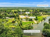 This Riverfront View Home also has an 8 Car Garage Total with a Shop