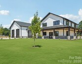 Brand New Barndominium House .. It has a 6 Car Garage with Soaring 16 to 18 Foot Tall Garage Doors and 400-amp Service Panel